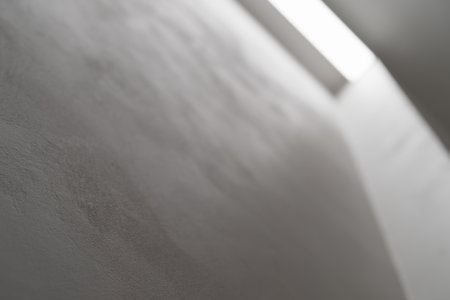 Abstract photo of white wall with light reflection from a light barの写真素材