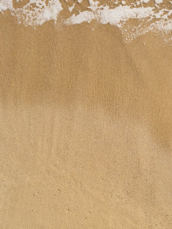 Fine sand beacg got wet by sea wavesの写真素材