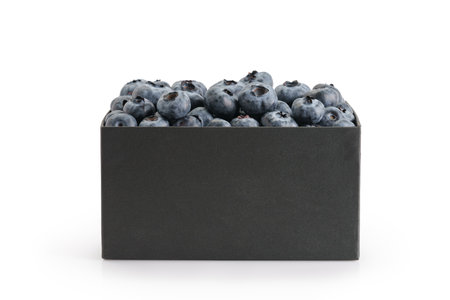 Fresh premium blueberries in black paper box isolated on white backgroundの写真素材
