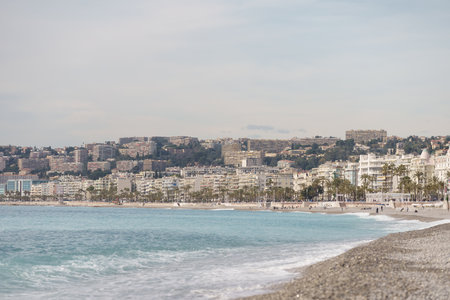 Nice, France - March 8 2021: Nice beach with people chilling during warm spring dayのeditorial素材