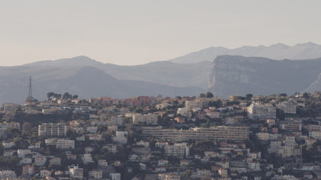 Nice, France - March 16, 2023: Panoramic view of Nice City with mountains on background