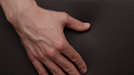 Closeup man checking leather quality on furnitureの写真素材