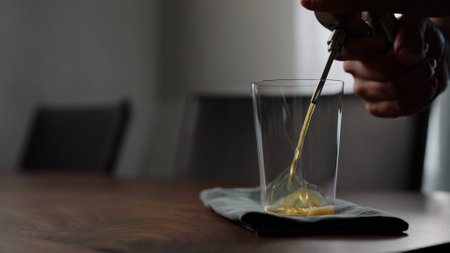 pour nitro coffe in tumbler glass on wood tableの写真素材