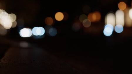 Bokeh background of night city with car light passing byの写真素材