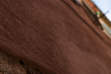Closeup Dark terracotta mediterranean old wall plaster rough background