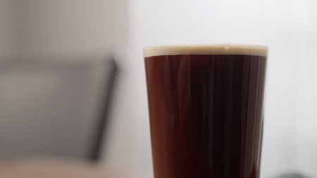making nitro coffee in thin glass on walnut tableの写真素材