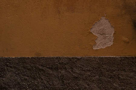 dark ocher plaster wall of old mediterranean cityの写真素材