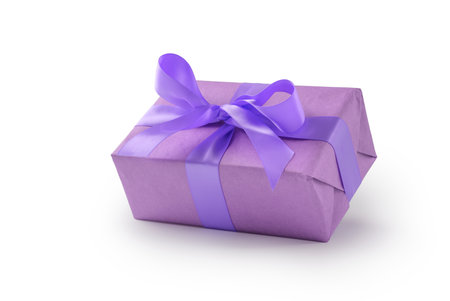 Purple paper present box with ribbon bow isolated on white backgroundの写真素材