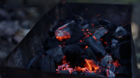 Handheld shot of charcoal in brazier, preparation for bbqの写真素材