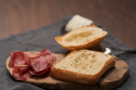 Ingredients for sandwich with bresaola, pesto and balsamic on olive boardの写真素材