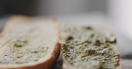 pesto on baguette halves, making sandwichの写真素材