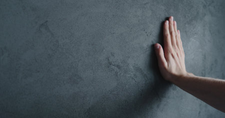 man hand touches decorative concrete finishの写真素材