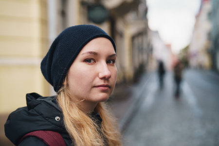 portrait of teen girl walking in Old Tallinn in autumnの写真素材