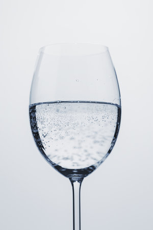poured mineral water in wine glassの写真素材