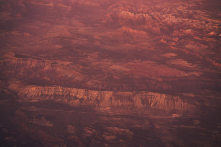 view from plane during flight over California mountains in sunsetの写真素材