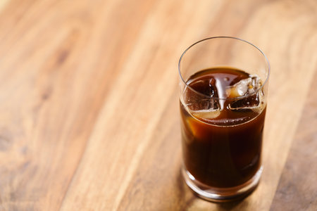 Glass of iced coffee on wooden tableの写真素材