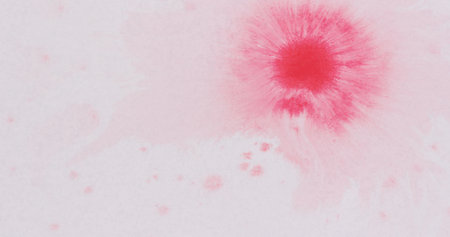 pink ink drops spreads on white wet paperの写真素材