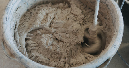 mixing concrete plaster with electric mixerの写真素材