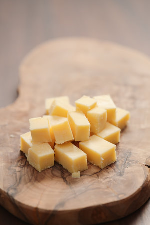 Pieces of hard vintage cheese on wood olive boardの写真素材