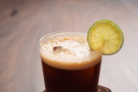 Espresso tonic in simple glass on walnut wood table with copy spaceの写真素材