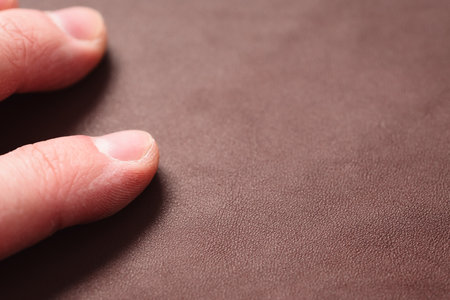 man hand check grain brown closeup leather shotの写真素材