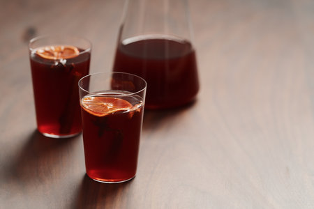 Mulled wine in tumbler glasses on walnut table with copy spaceの写真素材