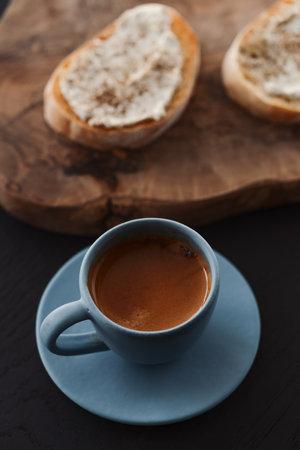 Espresso in blue cup with sandwiches with cream cheese on backgroundの写真素材