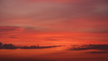 Sunset clouds in the sky in summer eveningの写真素材