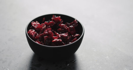 dried cranberry in black bowl on terrazzo countertopの写真素材