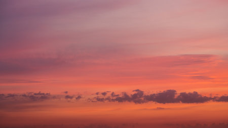 Sunset clouds in the sky in summer eveningの写真素材