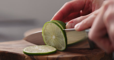 man hands slicing lime with knifeの写真素材