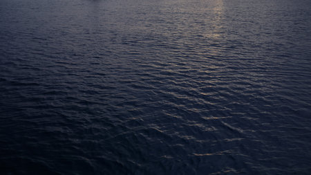Closeup footage of ocean water surface during dawnの写真素材