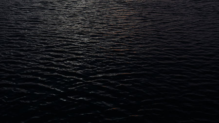 Closeup footage of ocean water surface during dawnの写真素材