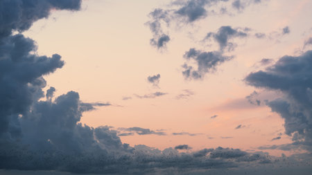 Evening clouds in the sky in summer evening with warm light