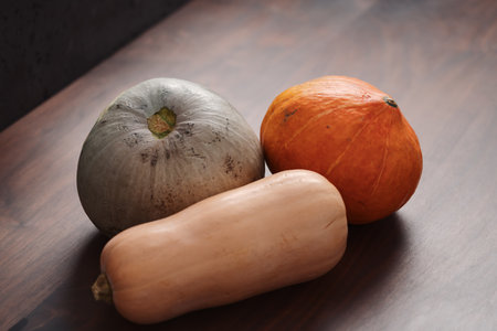 Different pumkins on walnut wood table