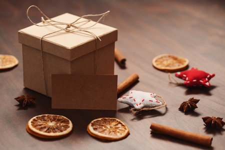 Christmas gift box from eco friendly paper wrapped with natural twine on wood table with natural...
