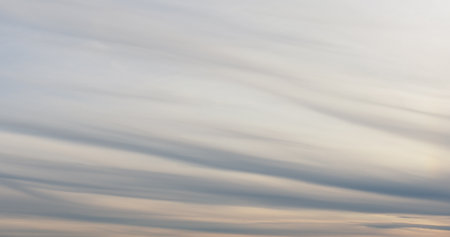background of spindrift clouds on evening skyの写真素材