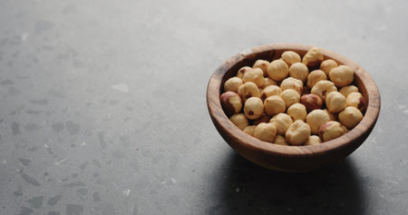 roasted hazelnuts in olive bowl on terrazzo countertop