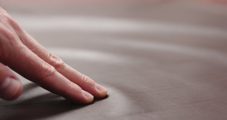 man hand checking brown leather piece closeupの写真素材