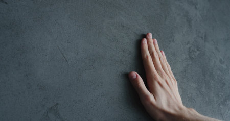 man hand touches decorative concrete finishの写真素材