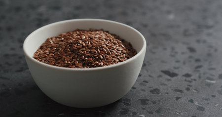 flaxseed in white bowl on terrazzo countertop with copy spaceの写真素材