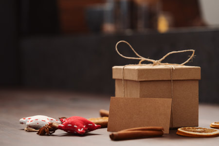 Christmas gift box from eco friendly paper wrapped with natural twine on wood table with natural decorationsの写真素材
