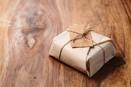 Chocolate brick wrapped in paper on wood background