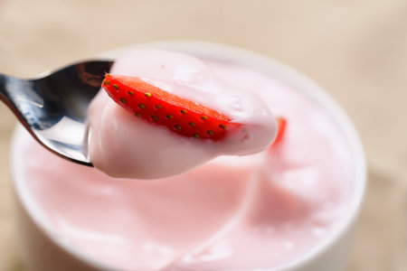eat strawberry yogurt in white bowl closeup shotの写真素材