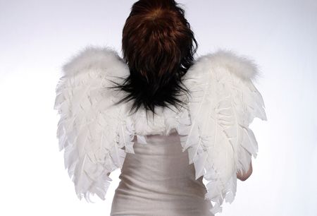 girl dressed as angel looking toward heaven