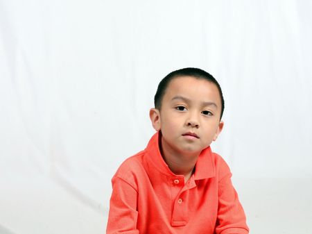 serious asian boy isolated on white backgroundの写真素材