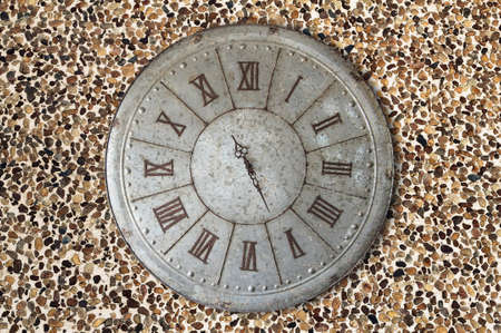 Wall clock old rusty grunge on stone wall backgroundの写真素材