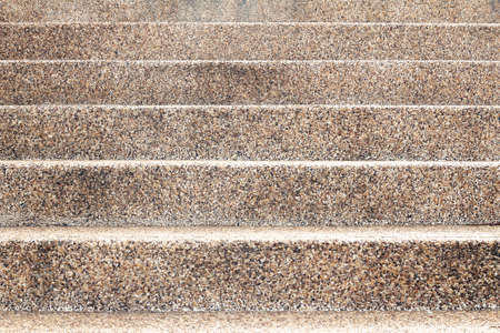 The abstract geometrical background formed by straight lines of a concrete ladder and a pebble wallの写真素材