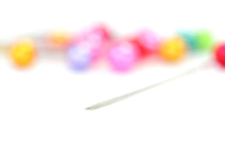 Photos of push pins focuses on the sharp pins on a white backgroundの写真素材