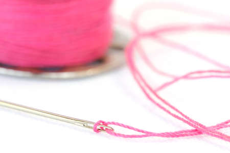 Sewing needle and Yarn on a white background , Focused on Hole needleの写真素材